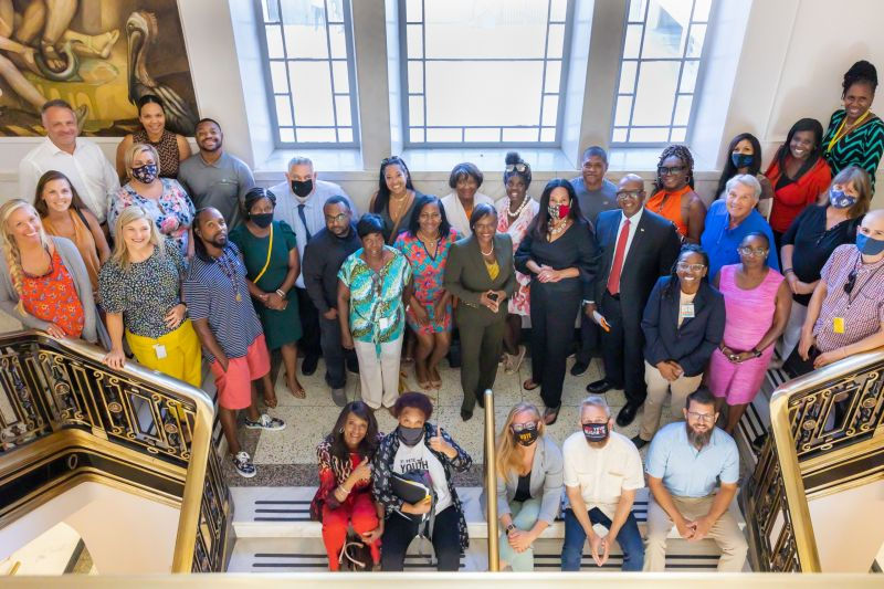 Advocates after the unanimous vote to adopt the CBA Policy, with Deputy Mayor Dr. Kanika Tomalin (center, standing). Also visible are Councilmembers Amy Foster and Brandi Gabbard (left) and Lisa Wheeler-Bowman (far right), along with current mayoral candidate Ken Welch. Photos courtesy of All Photos Considered