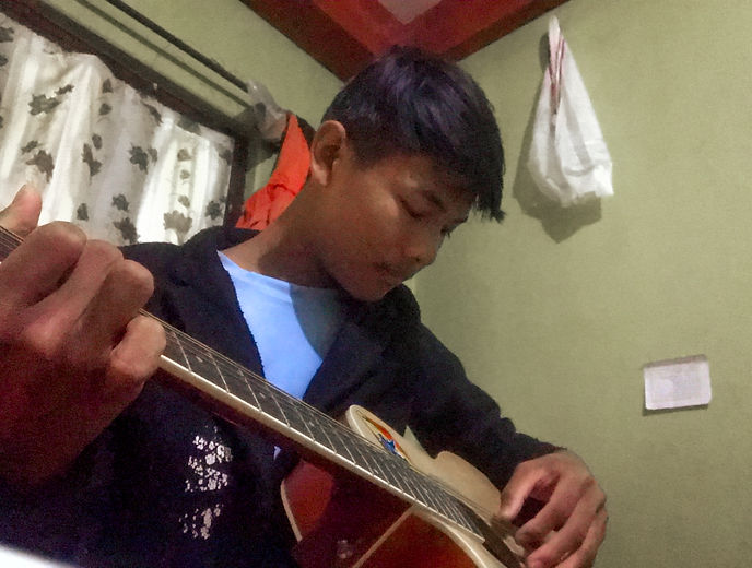 Sabin Tumsing playing guitar