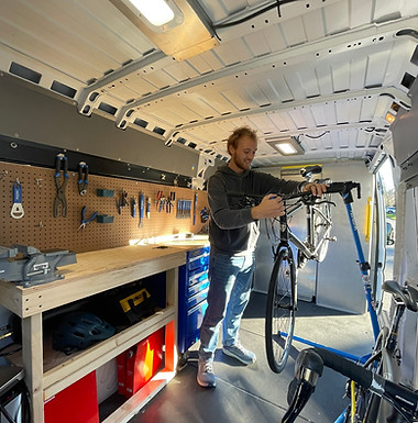Dayne working on a bike in the van