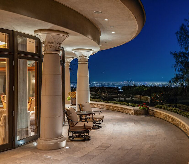 Covered outdoor terrace overlooking the landscape at dusk