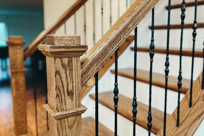 Wood staircase and railing with black metal railings