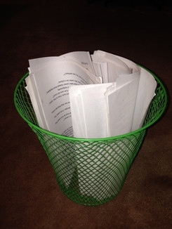 wastebasket full of printed manuscripts that were rubbish