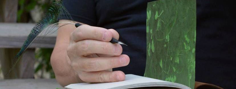 The autho with a quill penand leather-bound journal.