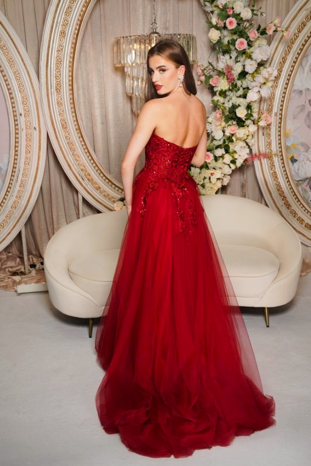 Thumbnail: back view of prom dress in burgundy showing the trail on tulle skirt