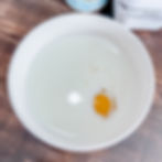 wet ingredients of irish soda bread in a white bowl on a wooden table