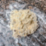 irish soda bread dough on a floured counter about to be formed in a dough ball