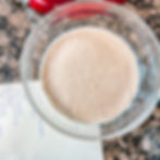 A bowl of active yeast sits next to a red mixing bowl and a recipe on paper. His Girl Sunday provides Catholic liturgical living recipes for Lent.