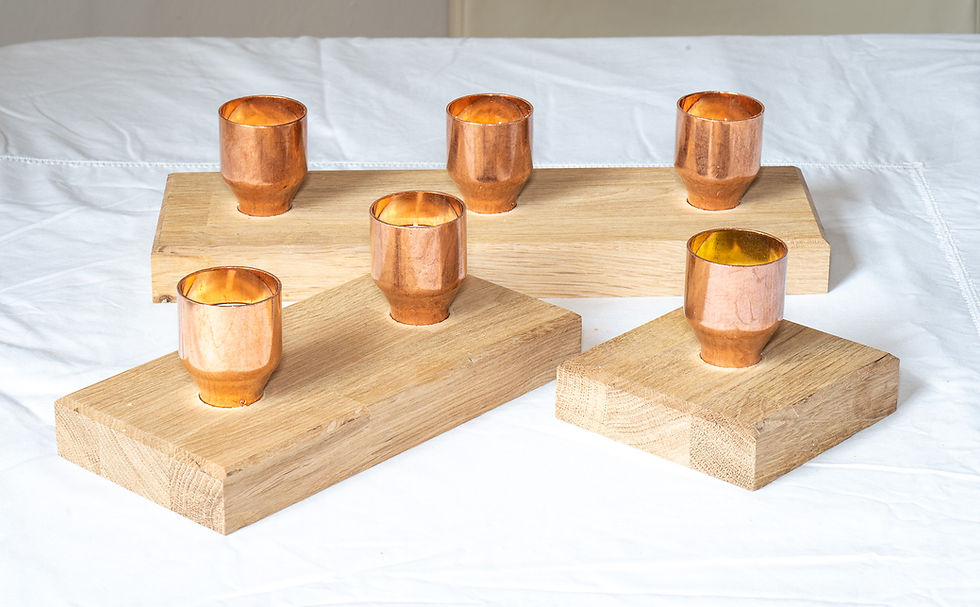 Copper candle holders on wooden base