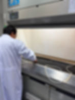 Technician in white coat testing equipment for บริการ