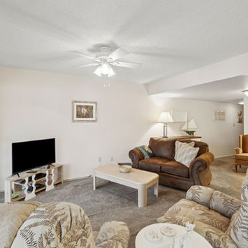 Open living room with river views at 210 River Bend Place Building B Welaka condo by Margaret Zahner