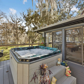 Hot tub on the back deck overlooking the lake at 213 E Char Lane in Crescent City Florida by Margaret Zahner