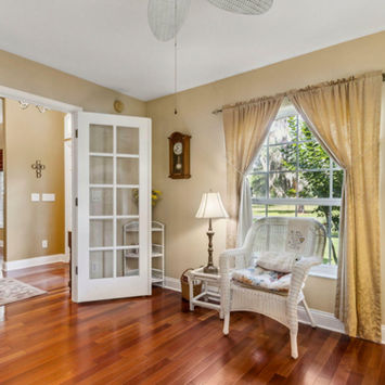 Elegant front parlor with 12-foot ceilings in the gated waterfront home at 166 Mount Royal Avenue Crescent City