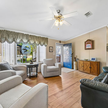 Open living area with natural light and water views at 334 Paradise Circle Satsuma FL by Margaret Zahner