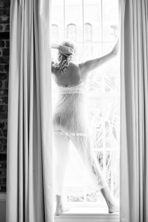 Black and white boudoir photography by Chucktown Art, photo session held in downtown Charleston at The Vendue.