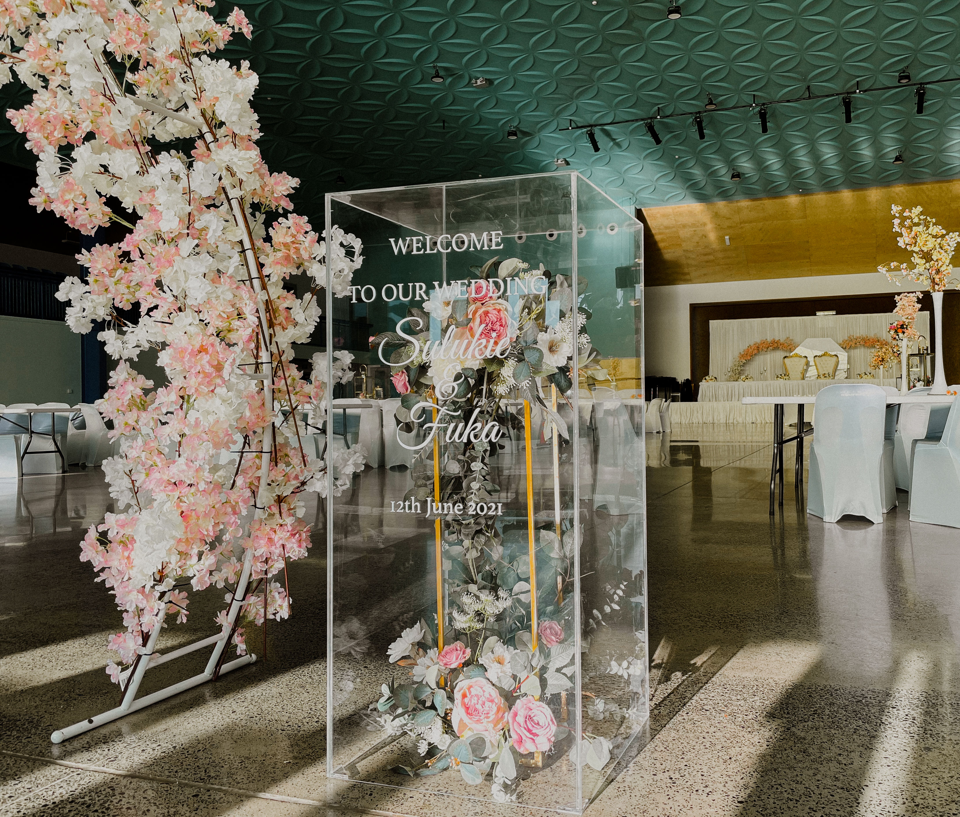 Acrylic Plinth with wording and flower arrangement