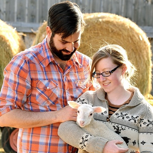 Photo 1: Cait and Kyle with one of their lambs. Photo by Steve Maddock, 2012.