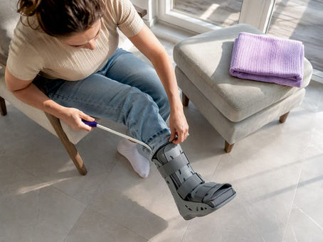 Using a dressing stick over a walking boot