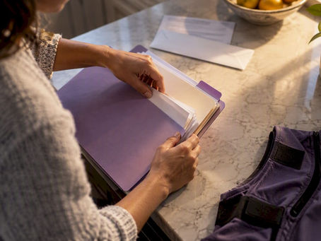 Caregiver organizing adaptive clothing claim paperwork