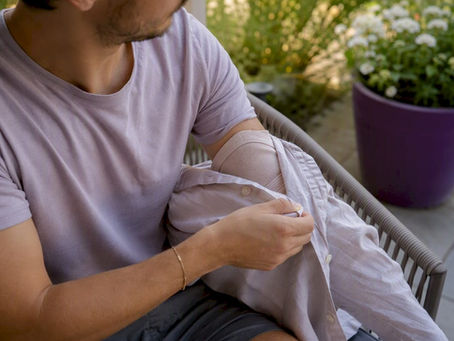 Person dressing arm in front-opening shirt
