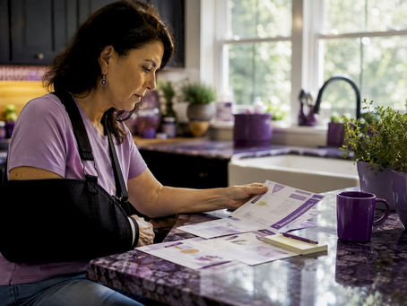 Woman reviewing bone health materials at desk