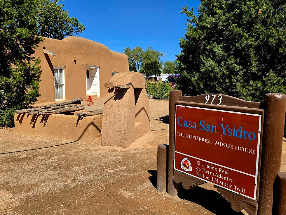 Casa San Ysidro sign in front of an adobe building.