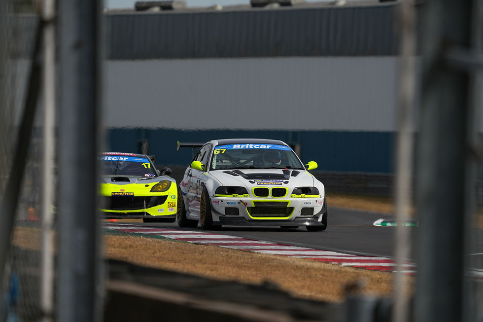Julian McBride being chased by a Ginetta out of Roberts at Donington Park.
