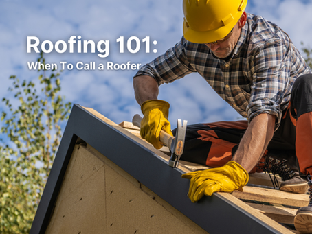 Roofing 101: When To Call a Roofer text over a roofer in yellow hard hat and gloves nailing roof trim against blue sky