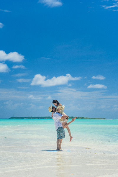 Couple enjoying playful moment on tropical beach paradise