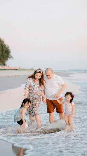 Happy multi-generational family enjoying beach vacation together