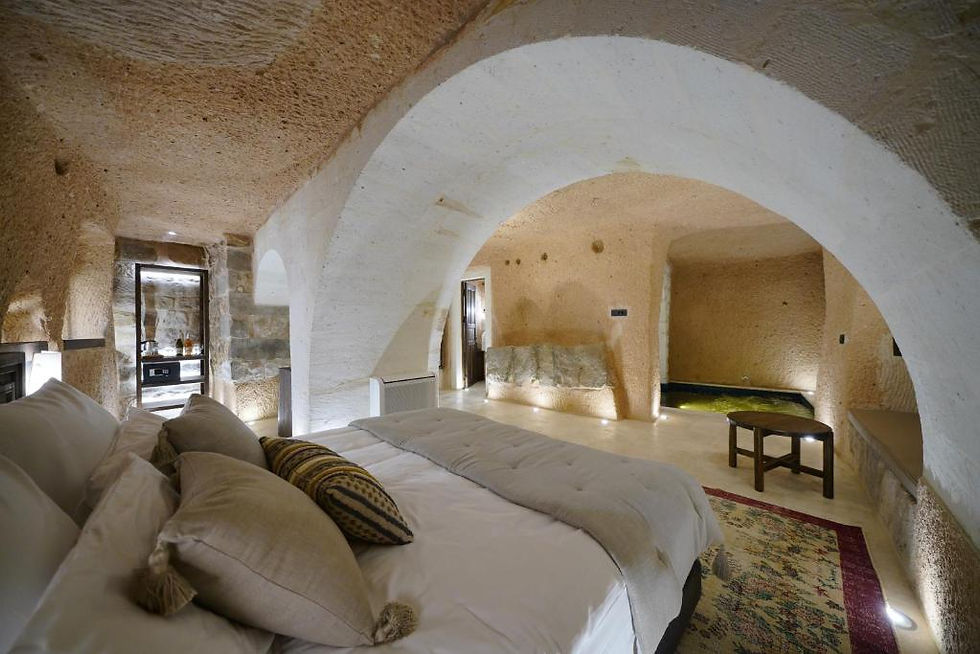 Luxury cave hotel room interior in Cappadocia with stone walls and cozy design