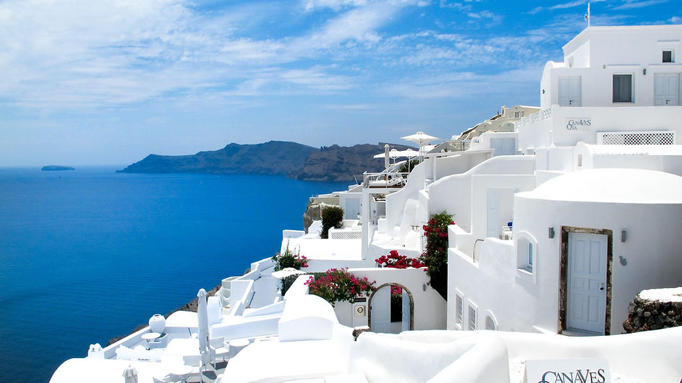 ALT TEXT: Best time to visit Greece showing Santorini Oia whitewashed buildings overlooking the Aegean Sea