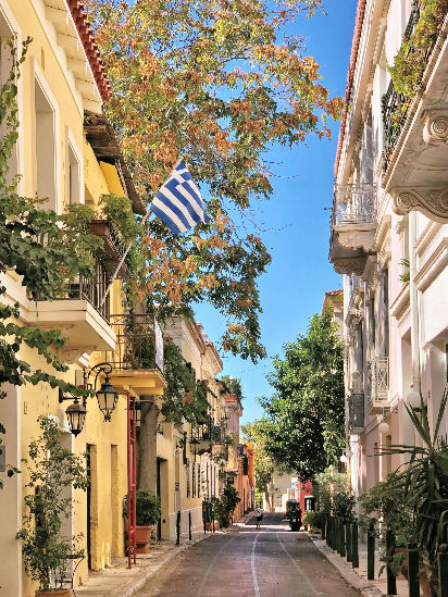 Traditional houses and Greek flag in Plaka neighborhood Athens