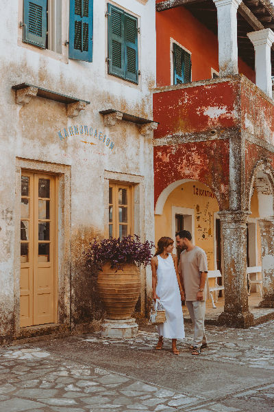 Couple walking in charming old town street Greece romantic retreat