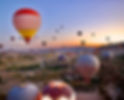 Hot air balloons rising over Cappadocia’s fairy chimneys at sunrise, Turkey