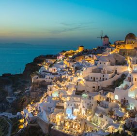 Santorini Oia sunset view with white houses and blue domes, one of the best Greek islands to visit.