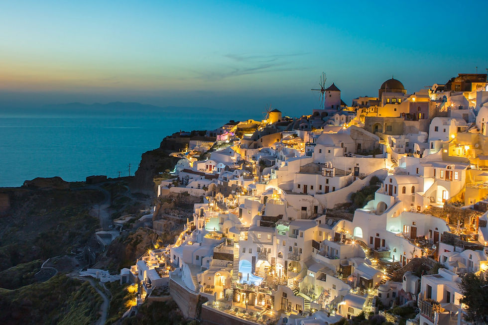Santorini Oia sunset view with white houses and blue domes, one of the best Greek islands to visit.