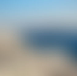 Whitewashed Greek island buildings overlooking the blue Aegean Sea