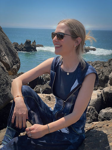Jackie smiling sideways on large rocks