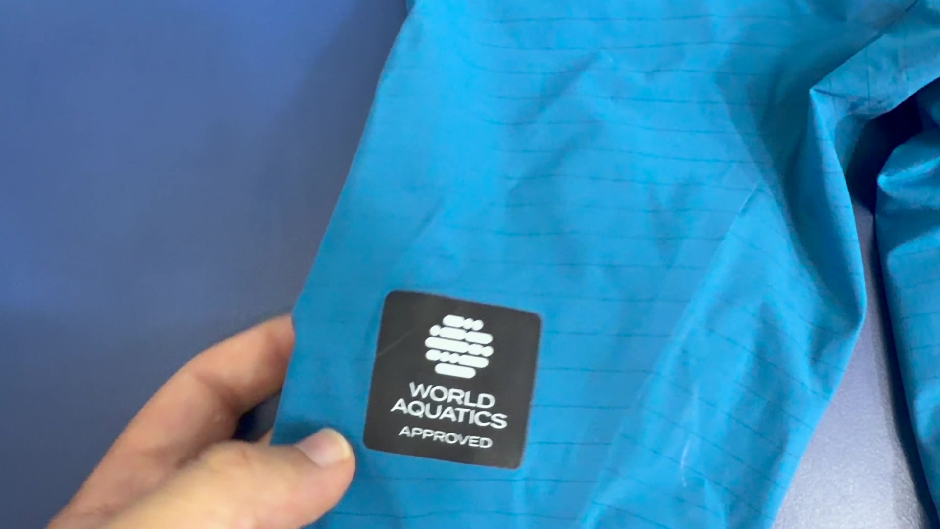 New 40 x 40 mm World Aquatics Approved badge on the front thigh of the Arena Air 3