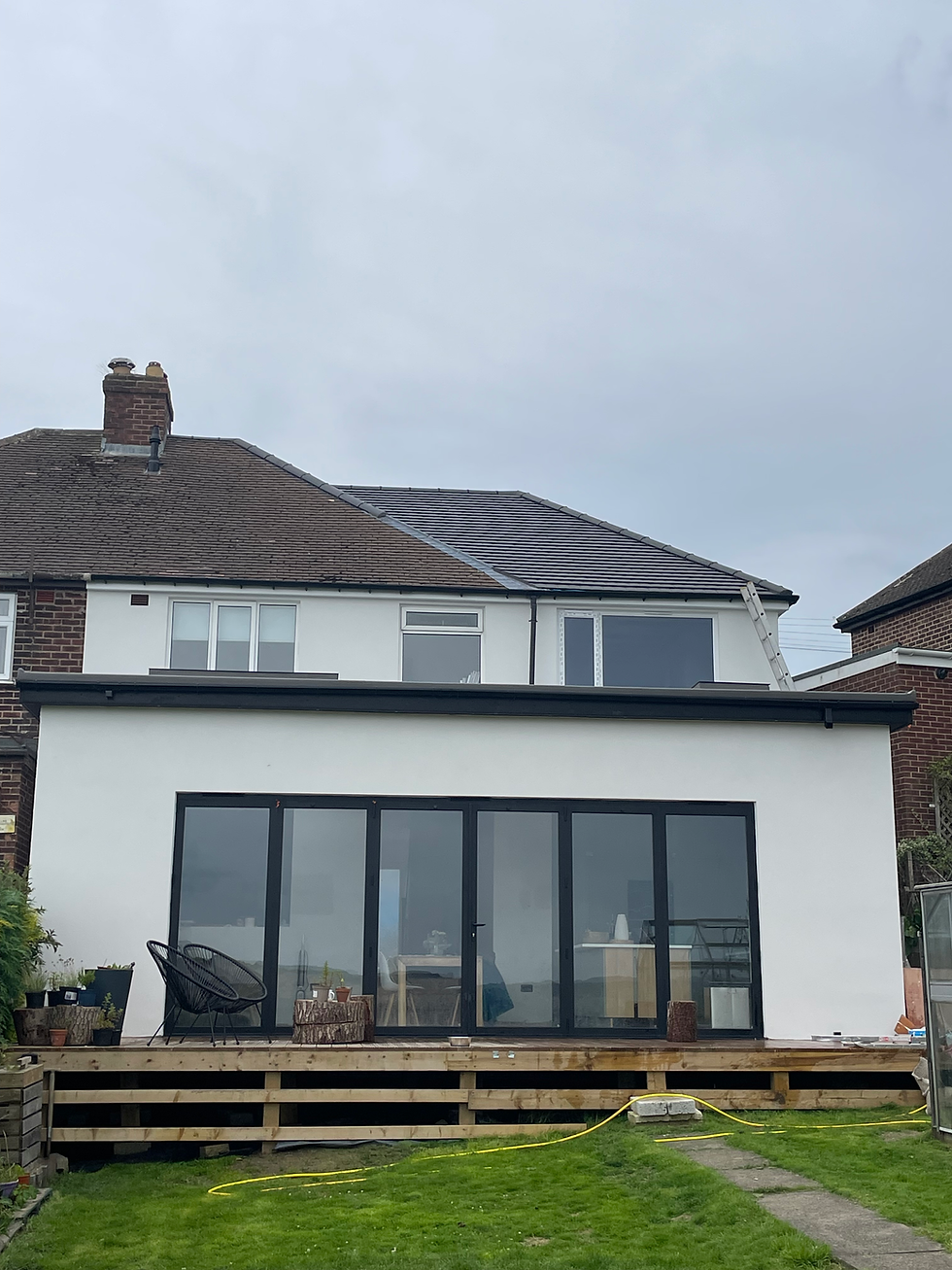 Rear house elevation and extension in Sheffield rendered in white silicone, featuring bi-fold doors and precision finish by Plaster and Rendering Solutions. Source: Plaster and Rendering Solutions