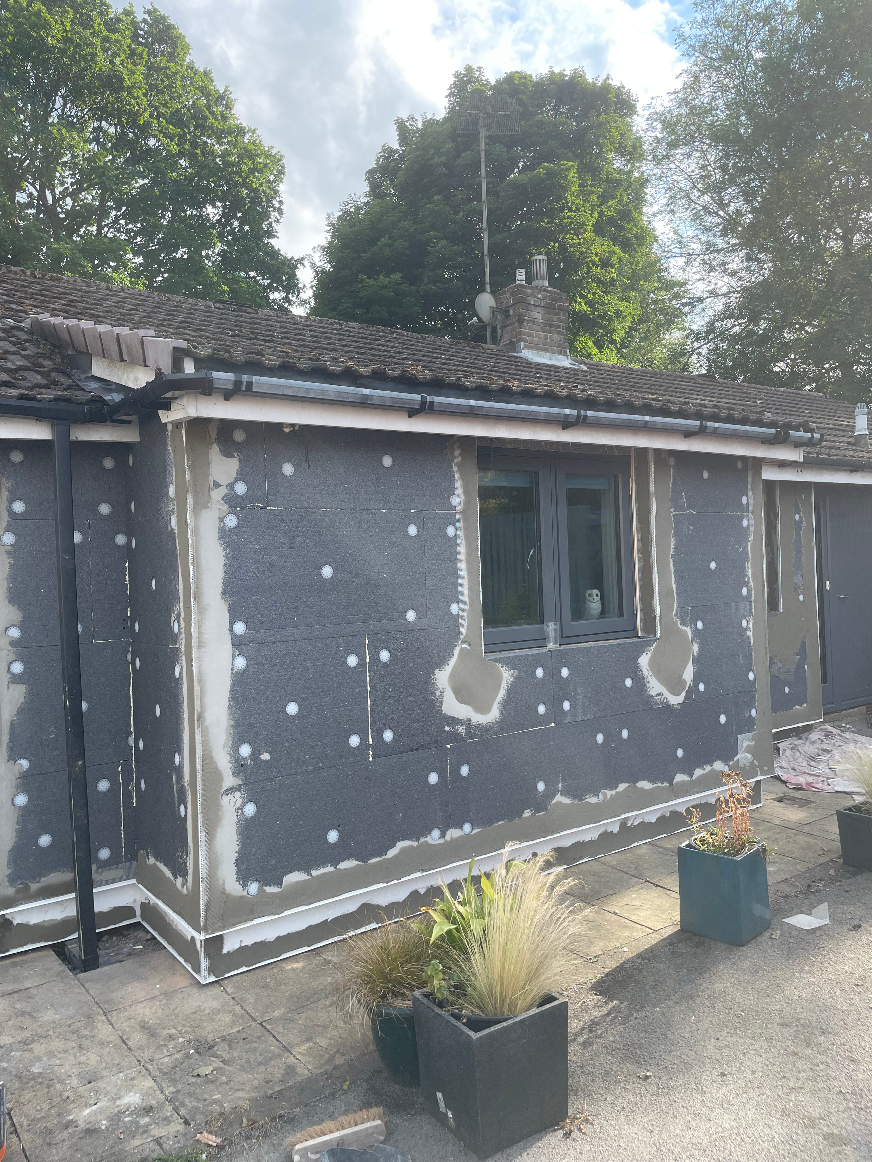 Installing EPS insulation boards for an EWI project in Abbeydale, Sheffield S17, by Plaster and Rendering Solutions.