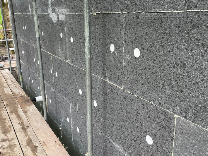 EWI insulation boards fixed to a gable wall of a house during installation in Sheffield.