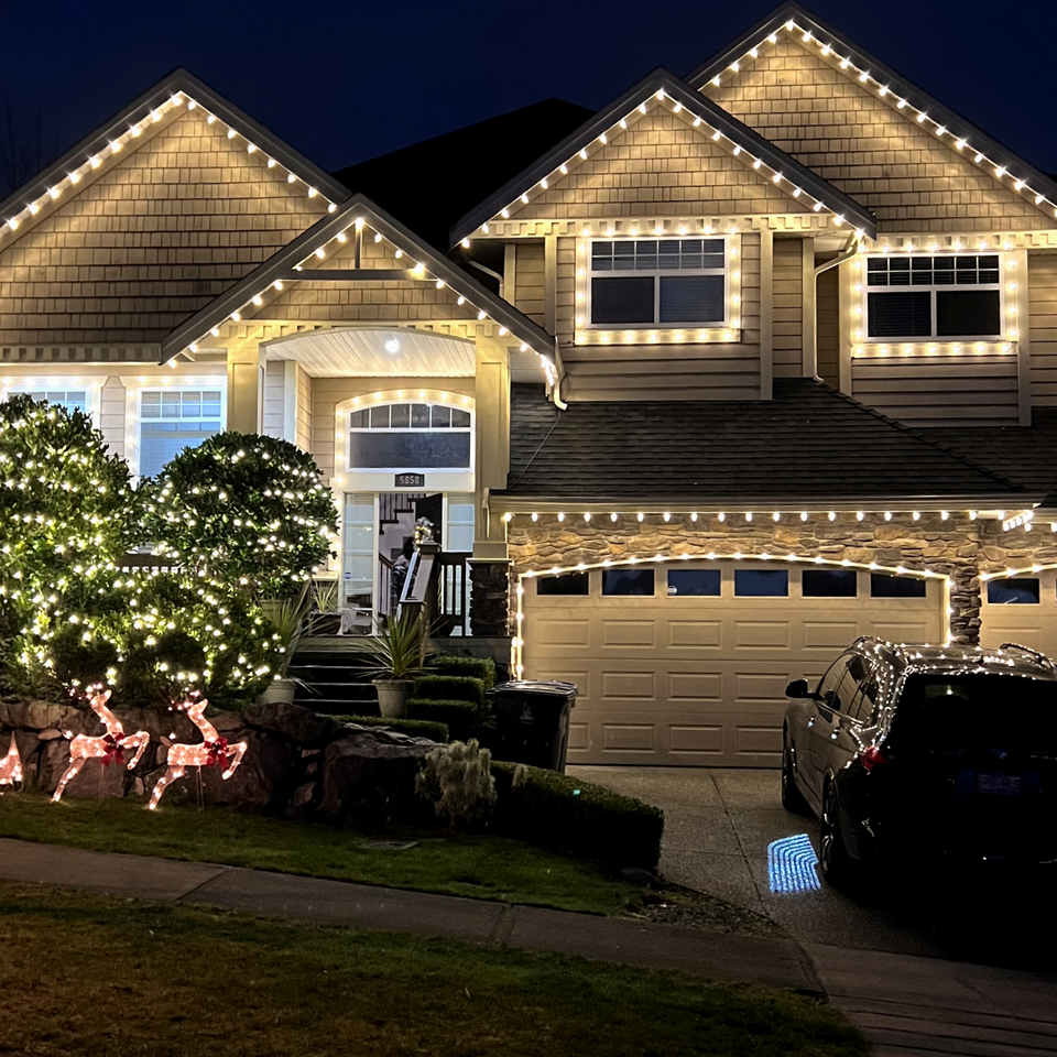Warm white incandescent LED C9 exterior string lights holiday light installation on house roofline Christmas lights installed by The Christmas Experts
