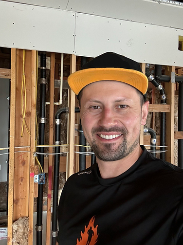 Owner of Holly Springs Handyman smiling at a home renovation site, showcasing craftsmanship and professional handyman services in Holly Springs, NC.