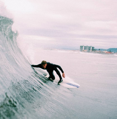 Surfing right hander wave with a long fish surfboard