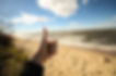A young woman gives a thumbs up as she enjoys the beach on Kent Island, Maryland in Queen