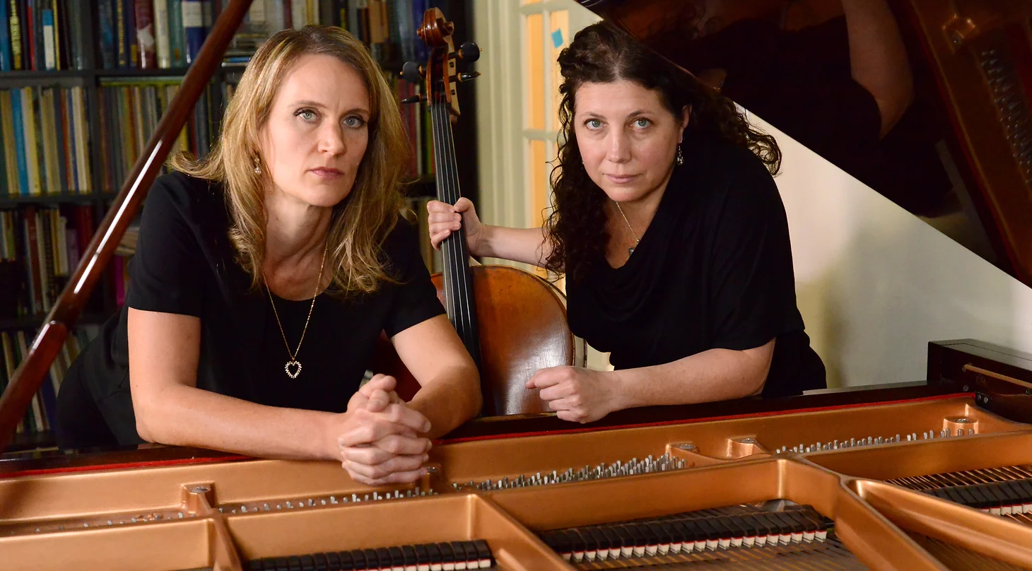 A portrait of Alyson Berger and Amy Wurtz with their cello and piano