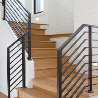 Staircase with light, natural wood flooring