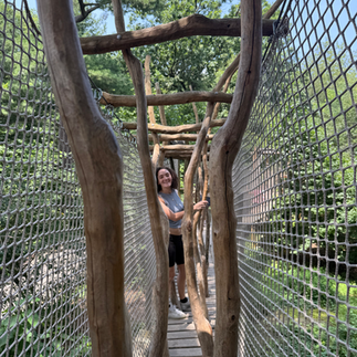 Lady climbing through The Bronx Zoo nature trek