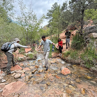 Group carefully crossing Kanarra Falls, Utah